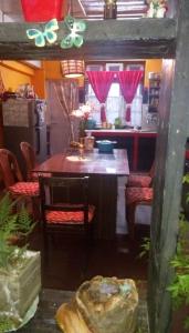 a kitchen with a table and chairs and a kitchen with a kitchen at Vamoose D'souza in Darjeeling