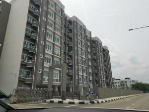 a large apartment building on the side of a street at Cozy 3 Bedrooms Apartment Langkawi in Kuah