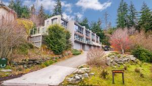a large building on a hill with trees at Vancouver Spa Views in Queenstown