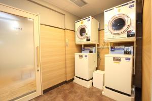 a laundry room with a washer and dryer at Hotel Nature Nagoya Sakae Kishu Railway Group in Nagoya