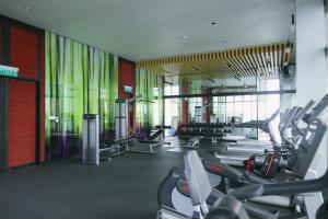 a gym with a lot of treadmills and machines at Tropicana Residence KLCC @ Getaway Home Suite in Kuala Lumpur