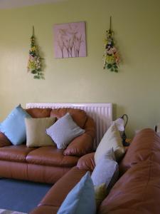 a living room with a couch and two christmas trees at Stone House Farm (Adults Only) in Lyng