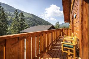 eine Terrasse mit zwei Stühlen in einer Hütte in der Unterkunft Apartmánový dom Poludnica - Chopok Juh in Tale