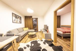 a living room with a cow laying on the floor at Apartmánový dom Poludnica - Chopok Juh in Tale