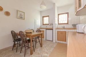 eine Küche mit einem Holztisch und Stühlen in der Unterkunft Glamping Green Istria Tiny Houses in Truške
