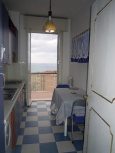 a kitchen with a table and a view of the ocean at Casa Alessandra in Lerici