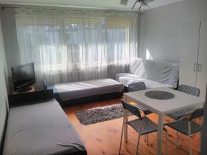 a living room with a couch and a table and chairs at Pokoje u Kamy in Ustka