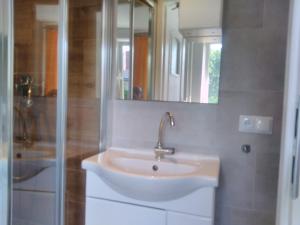 a bathroom with a sink and a shower at Pokoje u Kamy in Ustka +22 photos