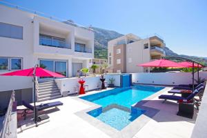 a villa with a swimming pool and a building at Villa Inis in Makarska