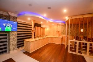 a large bathroom with a television and a large tub at Galaxy Grand Hotel in Nuwara Eliya