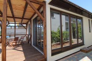 a screened in porch with glass doors on a house at Vacation house in Chornomorsk