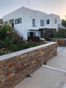 a brick retaining wall in front of a house at Nefeli in Livadi