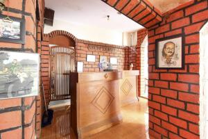 a room with a brick wall with a bar in it at RedDoorz Syariah At Jalan Menteri Supeno in Yogyakarta