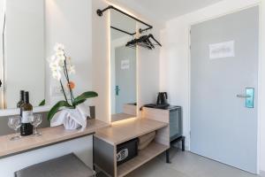 a dressing room with a mirror and a sink at Lymberia Hotel in Faliraki +30 photos