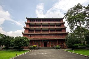 a large red building with stairs in a park at Guangzhou Seaman Club in Guangzhou
