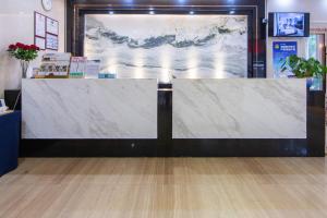 a large marble counter in a room with a large painting at Guangzhou Seaman Club in Guangzhou