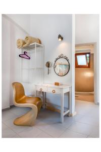 a white desk with a chair and a mirror at Tree of Life Art Hotel in Agia Marina Nea Kydonias