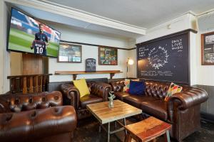 a living room filled with furniture and a coffee table at St Christopher's The Inn - London Bridge in London