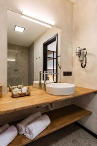 a bathroom with a sink and a mirror at C-Hotels Zeegalm in Middelkerke