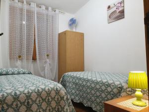 Ένα ή περισσότερα κρεβάτια σε δωμάτιο στο Casa Luciano