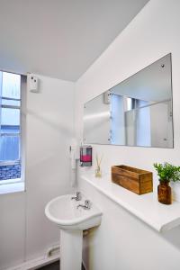 a bathroom with a sink and a mirror at St Christopher's The Inn - London Bridge in London