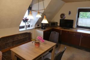 un soggiorno con tavolo in legno e una cucina di Ferienwohnung Irmgard a Nördlingen