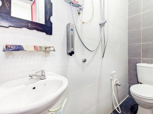 a bathroom with a shower and a sink at Super OYO 414 Adiff Palace Hotel in Sepang