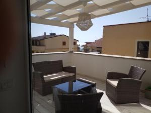 a patio with chairs and a table on a balcony at Mediterranean Apartments in Capo dʼOrlando