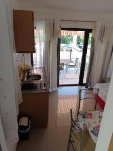a kitchen with a sink and a stove in a room at Apartments Vitae in Pula