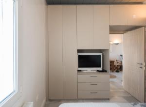 a living room with a tv in a wall at Bleland Mykonos II in Ano Mera