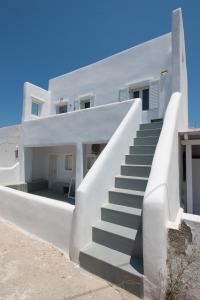 a white house with stairs in front of it at Bleland Mykonos II in Ano Mera