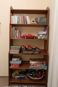 a book shelf with a toy car and books at Seaside in Agia Paraskevi
