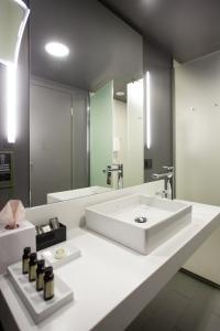 a bathroom with a white sink and a mirror at Pullman Riga Old Town in Rīga