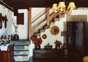 a room with a staircase and a table with flowers at Masia Can Solà Gros in Caldes de Malavella
