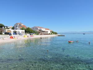 a group of people in the water at a beach at Apartment Blue Paradise in Preko