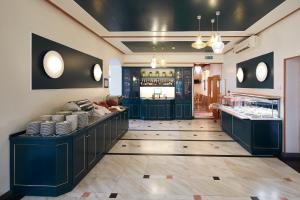 a restaurant with a counter with dishes on it at Hotel Villa Adriana in Monterosso al Mare