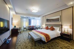 a hotel room with a large bed and a living room at Guangzhou Seaman Club in Guangzhou +69 photos