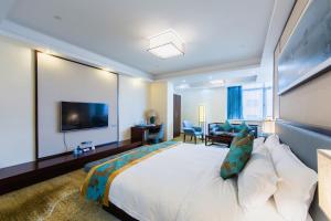a hotel room with a large bed and a flat screen tv at Guangzhou Seaman Club in Guangzhou