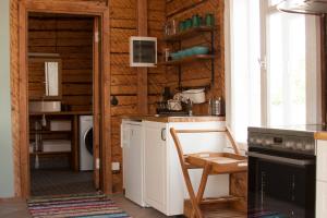 a kitchen with a table and a chair in a room at Pihtla Village Apartment in Pihtla
