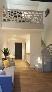 a living room with a couch and a staircase at APARTAMENTOS VALLE DE IROLA in Luanco