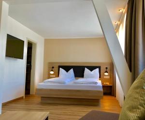 
a bedroom with a large bed and a large window at Flair Hotel Grüner Baum in Donaueschingen

