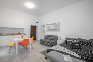 a kitchen and a living room with a table and chairs at Apartment Tara & Ana in Pula +8 photos