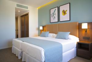 a large white bed in a hotel room at Riu Plaza España in Madrid