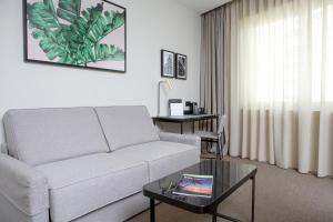 a living room with a couch and a table at Riu Plaza España in Madrid