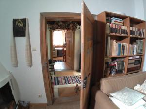 ein Wohnzimmer mit einer Tür, die zu einem Raum mit Büchern führt in der Unterkunft Casa Pintea - Bucovina in Kloster Humor