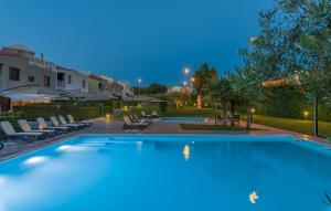 a large swimming pool in a yard at night at Maj Premium Residence in Poreč