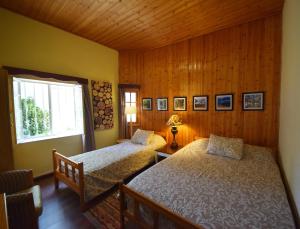 a bedroom with two beds and a window at Christys Palace Hotel in Pedoulas