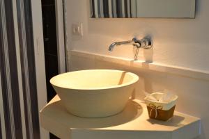 a bathroom with a white bowl sink on a counter at Masseria Romagnolo in Carpino