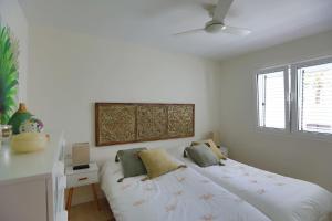 a white bedroom with a bed with pillows on it at Villa con piscina en Pasito PM34 in Pasito Blanco