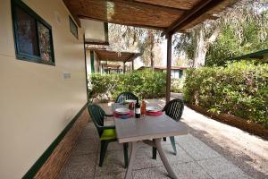 a table and chairs sitting on a patio at Acquaviva Village Camping in Portoferraio